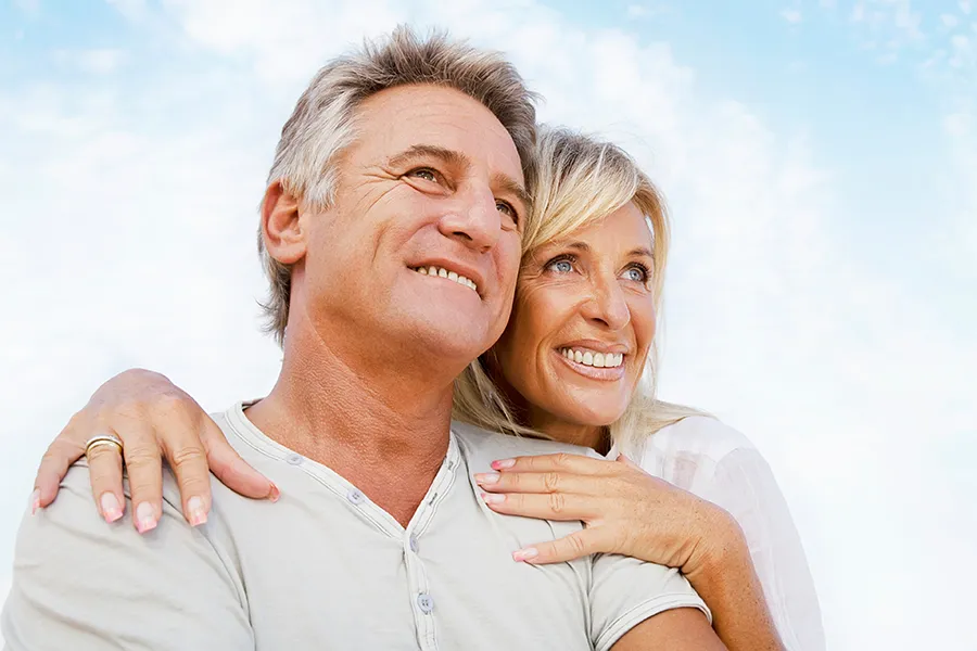 CJC-1295-Peptide-Clinic A mature couple embraces outside under the sky. Get CJC 1295 anti-aging peptides from Better Life Carolinas of Mount Pleasant in Charleston Metro.