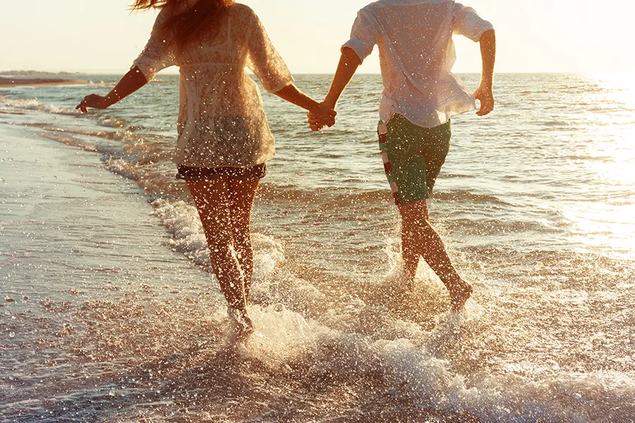 Epithalon-Peptide-Therapy-Clinic A couple run on the beach holding hands. Schedule Epithalon Peptide therapy from Better Life Carolinas of Mount Pleasant in Charleston Metro.