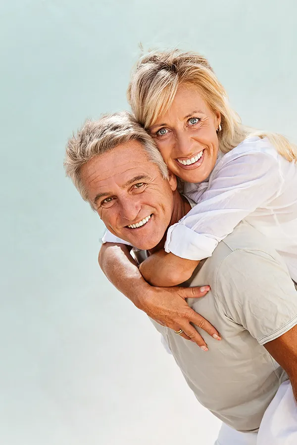 Food-Allergies-Treatment-1 A happy mature couple having fun - the husband is carrying his wife on his back. Get treatment for food allergies from Better Life Carolinas of Mount Pleasant in Charleston Metro.