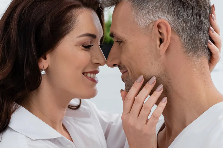 Gainswave-Clinic A middle-aged couple look into each others' eyes and grinning. Get Gainswave treatment for ED from Better Life Carolinas of Mount Pleasant in Charleston Metro.