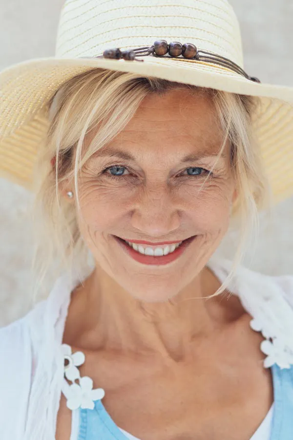 Menopause-Treatment A beautiful, smiling older woman with blonde hair and a sunhat, happy with menopause treatment from Better Life Carolinas of Mount Pleasant in Charleston Metro.