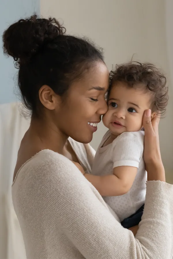 Postpartum-Hormone-Imbalance-Treatment A black woman happily touches her forehead to her infant's head. Get treatment for postpartum hormone imbalance from Better Life Carolinas of Mount Pleasant in Charleston Metro.