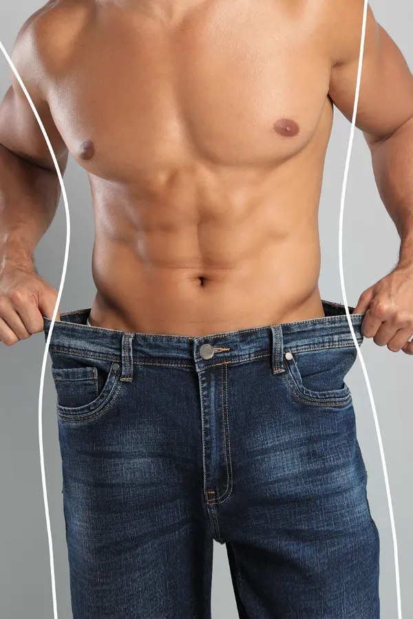 Semaglutide-Weight-Loss-Treatment A strong shirtless man in jeans holds the waistlines of his too-big jeans to show the success of semaglutide weight loss from Better Life Carolinas of Mount Pleasant in Charleston Metro.