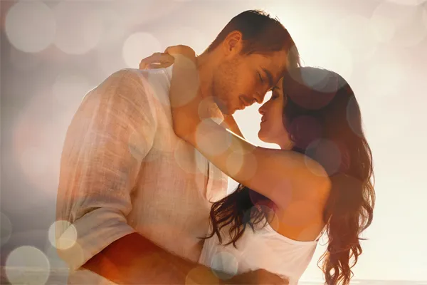 Sexual-Wellness-for-Women-and-Men-Doctor A couple in linen shirts standing in a sparkling light embraces each other with their foreheads touching and eyes closed, happy with their sexual wellness treatments from Better Life Carolinas of Mount Pleasant in Charleston Metro.