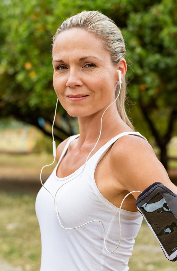 fibromyalgia-doctor Middle-aged, active woman taking a break to smile at the camera during a run, representing successful Bioidentical Hormones for Fibromyalgia Relief offered by Better Life Carolinas of Mount Pleasant in Charleston Metro.